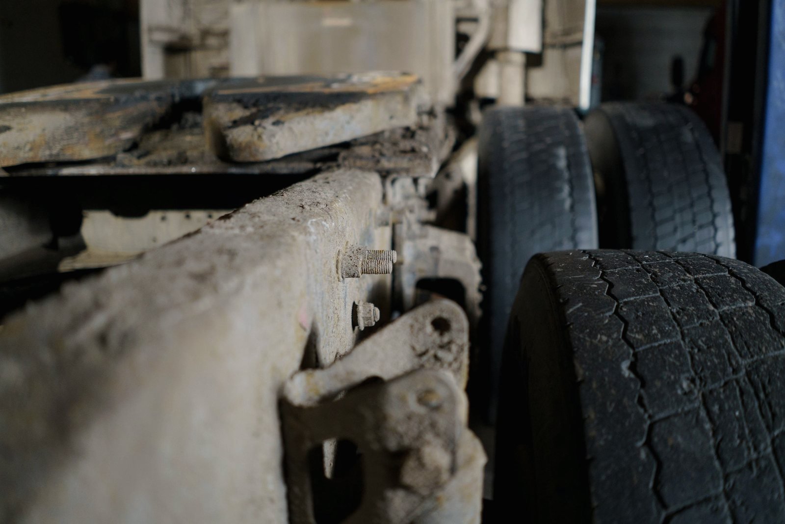 Chassis rail, spring hanger and dual tires seen from below a trailer